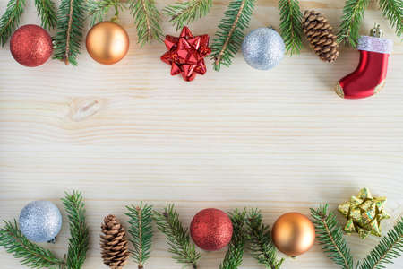 Christmas background with holiday decorations of fir branches , pine cones and balls. Copy space in the middle for textの写真素材