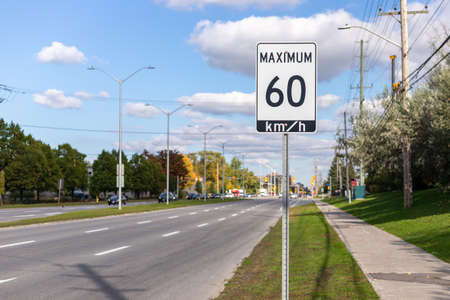 Speed limit road sign in the street, 60 km per hour maximum in Ottawa city, Canada. Traffic on the roadの写真素材