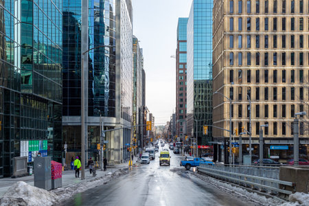 Ottawa, Canada - December 16, 2021: City view with skyscrapers and traffic on road and walking...