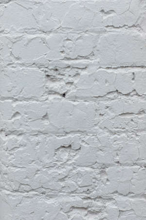Close up of painted light grey old brick wall texture background.の写真素材