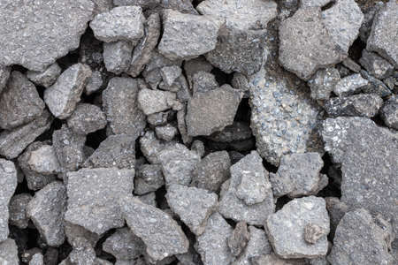 Pile of old cracked asphalt rubble close up, abstract industrial background.の写真素材