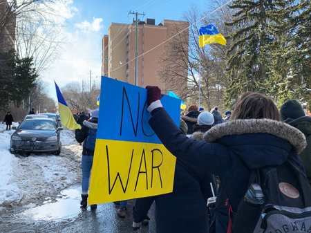 Ottawa, Canada - February 27, 2022: Rally in support of Ukraine against war. Protest and march against Russian invasion. People with Ukrainian flags and bannersのeditorial素材