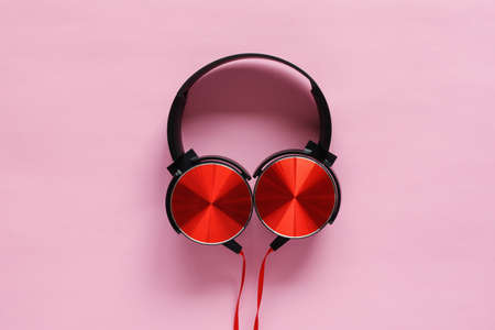 Red headphones isolated on the pink backgroundの写真素材
