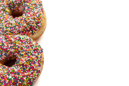Donuts with colorful sprinkles isolated on white background. High angle view with copy space for text.の写真素材