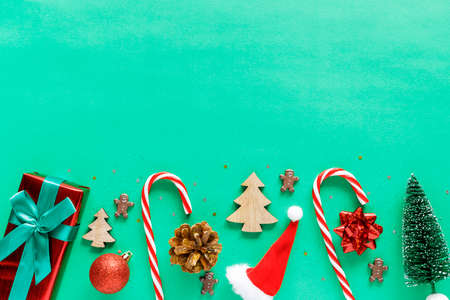 Christmas holiday decorations on green background with copy space for text. Flat lay composition.の写真素材