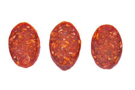 Salami sausage slices isolated on white background.の写真素材