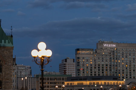 Ottawa, Canada - November 5, 2022: Cityscape of downtown at night with street lights, Westin hotel and other buildings along dark sky.のeditorial素材