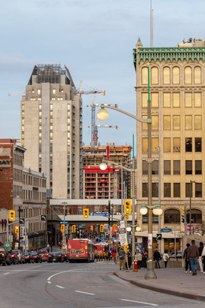 Ottawa, Canada - November 5, 2022: Busy traffic on Rideau street in downtown district. Cityscape with buildings, intersection, traffic lights, buses on the road and walking people.のeditorial素材