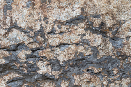 Old stone dark brown wall, textured background, close upの写真素材