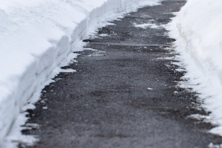 Winter sidewalk cleared of with snow.