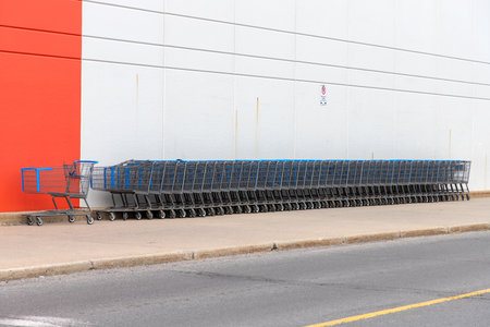 Kanata, Canada - June 2, 2024: Shopping carts outdoors near Walmart supermarket