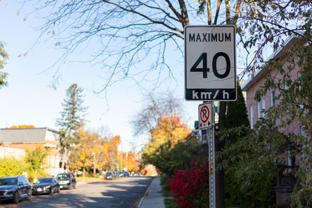 Speed limit road sign in residential district of Ottawa city in Canada in autumn.