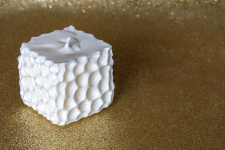 White soy handmade candle on golden background with copy apace.の写真素材