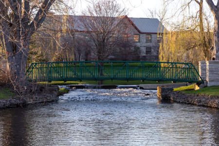A small footbridge over a stream in spring. Stewart Park In Perth, Ontario, Canada.