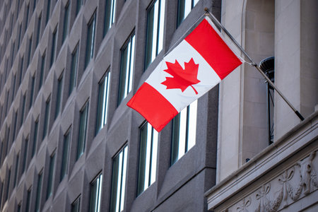 Canadian national flag displayed on urban architecture in Ottawa, Canadaの写真素材