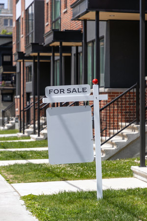 For sale sign in front of a residential buildingの写真素材