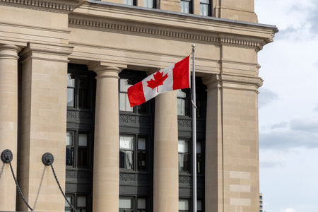Canadian national flag waving near the Senate of Canada buildingの写真素材
