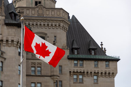 Canadian national flag near old heritage building in Ottawa, Canada.の写真素材