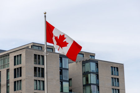 Canadian national flag in front of a building in downtown Ottawa, Canada.の写真素材