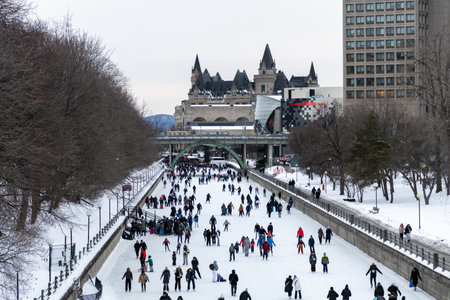 Ottawa, Canada - February 8, 2025: People skating on Rideau Canal in winter in city downtownのeditorial素材