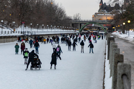 Ottawa, Canada - February 8, 2025: People skating on Rideau Canal in winter in downtown
