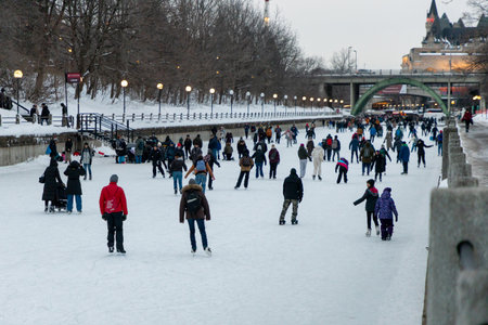 Ottawa, Canada - February 8, 2025: People ice skating on Rideau Canal on winter eveningのeditorial素材
