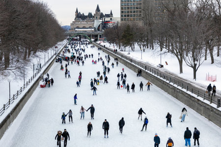 Ottawa, Canada - February 8, 2025: People skating on Rideau Canal rink in winter in downtown of...