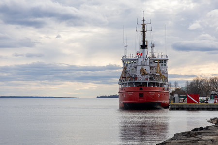 Prescott, Canada - April 6, 2025: Canadian coast guard vessel Griffon docked at pier. Ship with Canadian flag on riverのeditorial素材
