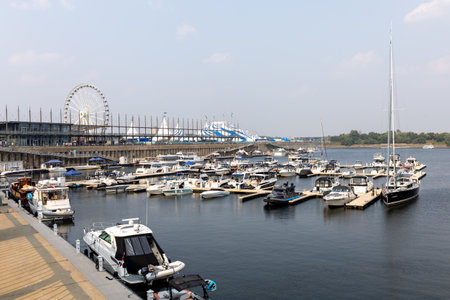 Montreal, Canada - August 2, 2025: Old Port of Montreal with Ferris Wheel. Harbor view with yachts...