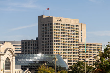 Ottawa, Canada - October 6, 2025: Canadian government building with flag in downtown of national capital city. Cityscape with architecture on sunny dayのeditorial素材