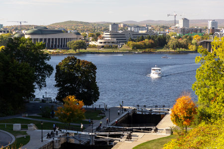 Ottawa, Canada - October 6, 2025: Rideau Canal locks with Canadian Museum of History in background. Ottawa River view with tour boat and Gatineau skylineのeditorial素材