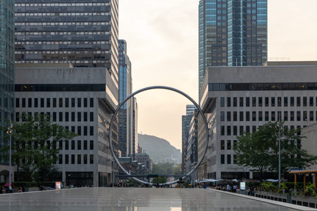 Montreal, Canada - August 2, 2025: L'Anneau ring sculpture at Place Ville Marie. Modern urban sculpture overlooking Mount Royal during summerのeditorial素材