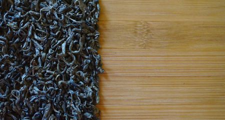 scattered green tea on wood bamboo backgroundの写真素材