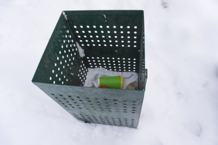 Green garbage can over with coffee cups.の写真素材