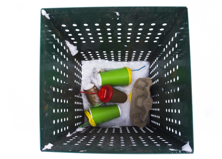 Green garbage can over with coffee cups top viewの写真素材