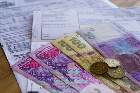 Ukrainian money hryvnia and coins penny wooden background, utility billの写真素材