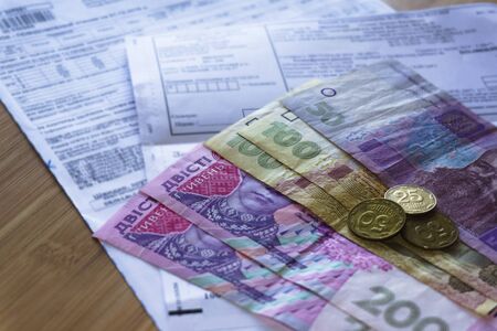 Ukrainian money hryvnia and coins penny wooden background, utility billの写真素材