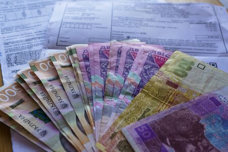 Ukrainian money hryvnia and coins penny wooden background, utility billの写真素材