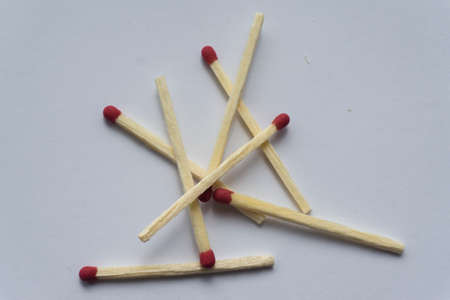 A pile of wooden matches in bulk. Several matches. White background. Top view.の写真素材