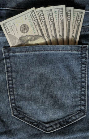 One hundred dollar banknote money in pocket jeans pants background texture. 100 dollar bill close up. Corruption.の写真素材