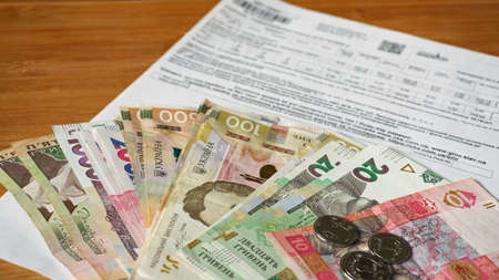 Ukrainian money hryvnia and coins penny wooden background, utility billの写真素材