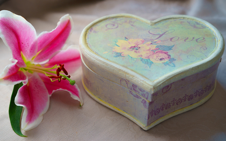 Vintage Retro style set bouquet of pink lily flower and handmade craft gift box in form of heart on natural color tablecloth board, Valentines Day, wedding day, Happy Birthday, datingの写真素材
