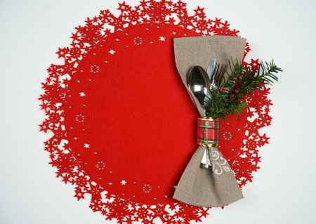 Top view Christmas And New Year Holiday Table Place Setting with branch of Christmas tree. Red woolen and white background. Winter holidays conceptの写真素材