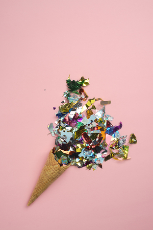 Christmas tree as ice cream with ice cream cone on dark pink background. Winter holiday party concept. minimalism layout. flat lay style. Top view copy spaceの写真素材