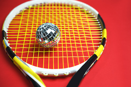 Christmas New year concept with disco ball as tennis ball on a tennis racket. top view, flat lay,...