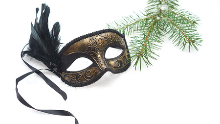 Image of elegant black and gold venetian, mardi gras mask on white snow background. Vintage photo. Christmas New Year carnaval Party night conception. Venice Carnival mask, close upの写真素材