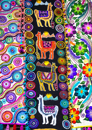 Peruvian traditional colourful native handicraft textile fabric with llama pattern at market in Peru, South Americain. Close up. selective focusの写真素材