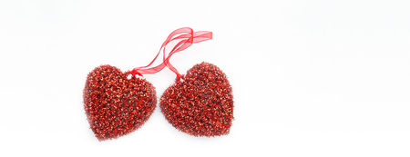 Two Red Valentine hearts in the snow, symbols of love. Background for Valentines day greeting card,...