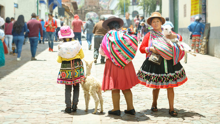 Cusco, Peru - 01.03.2019 Peruvian women and girl in traditional dresses and small llama on the street of Cusco, Peru, Latin Americaのeditorial素材