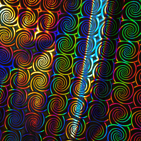 Holographic Abstract Foil Backdrop. Trendy creative hologram gradient rainbow. Flat lay, top view, selective focus.の写真素材